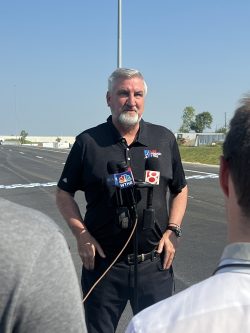 Govenor Holcomb speaking with media before the Connection of the Crossroads ribbon cutting