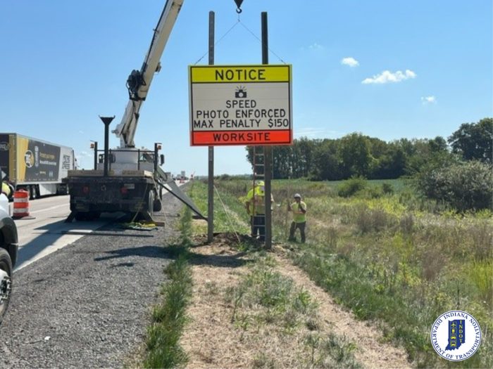 Employees placing the camera in worksite signs.