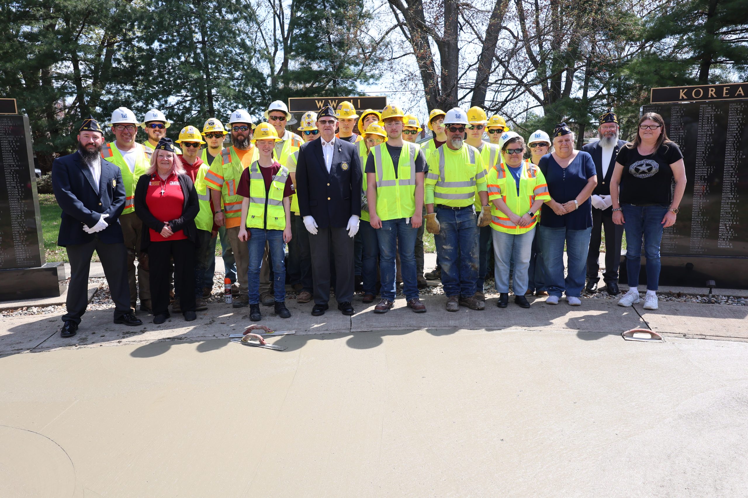 Milestone crew and Columbia City students in front of the freshly poured concrete