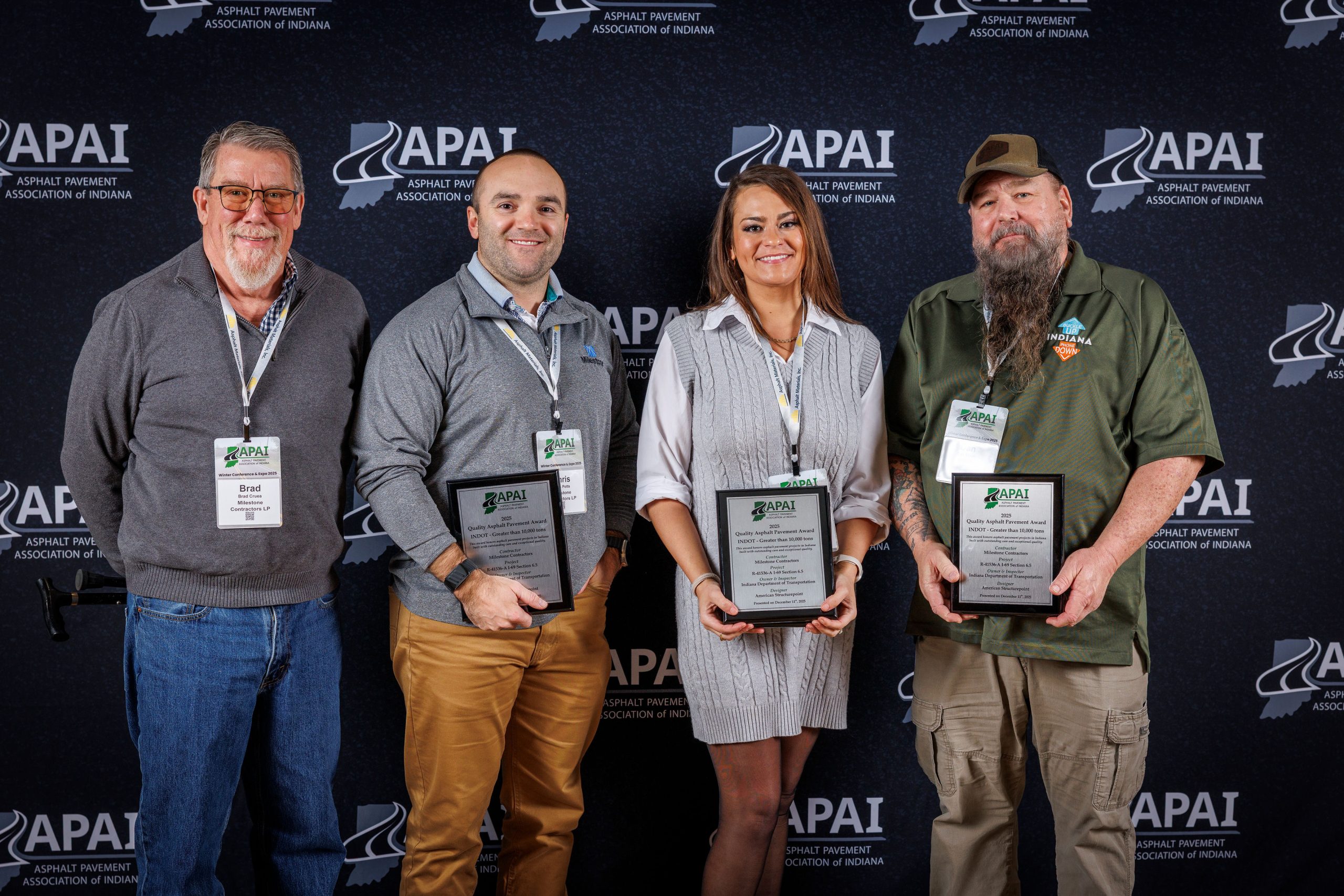 Milestone team members accept an APAI Quality Asphalt Pavement award. This is one of several construction awards received at the event.