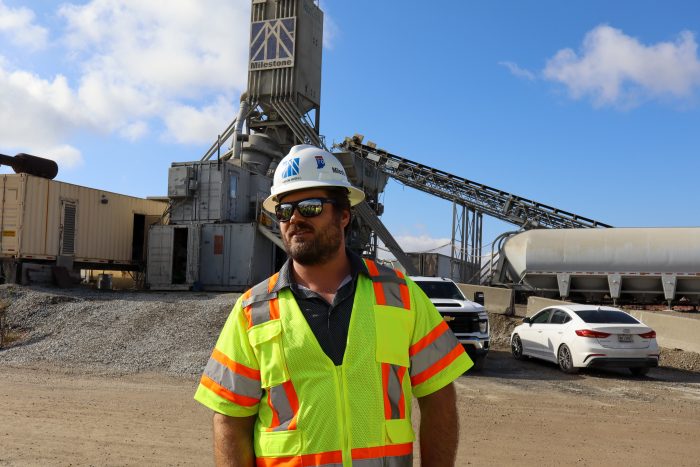 Rob Kish conducts a tour of an asphalt plant for students.