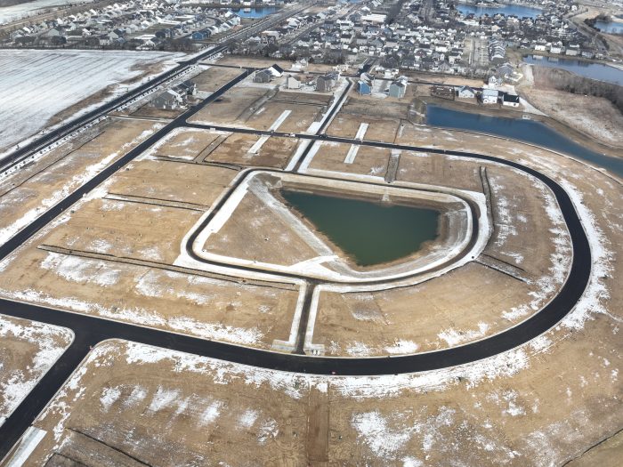 Milestone paves a web of asphalt roads before the developer begins building the houses.
