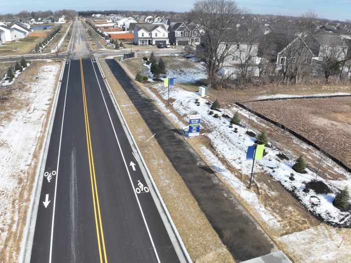Asphalt paving makes up a road just outside of a new neighborhood.